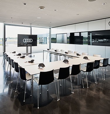 A large, bright conference room in the Motorsport Competence Center