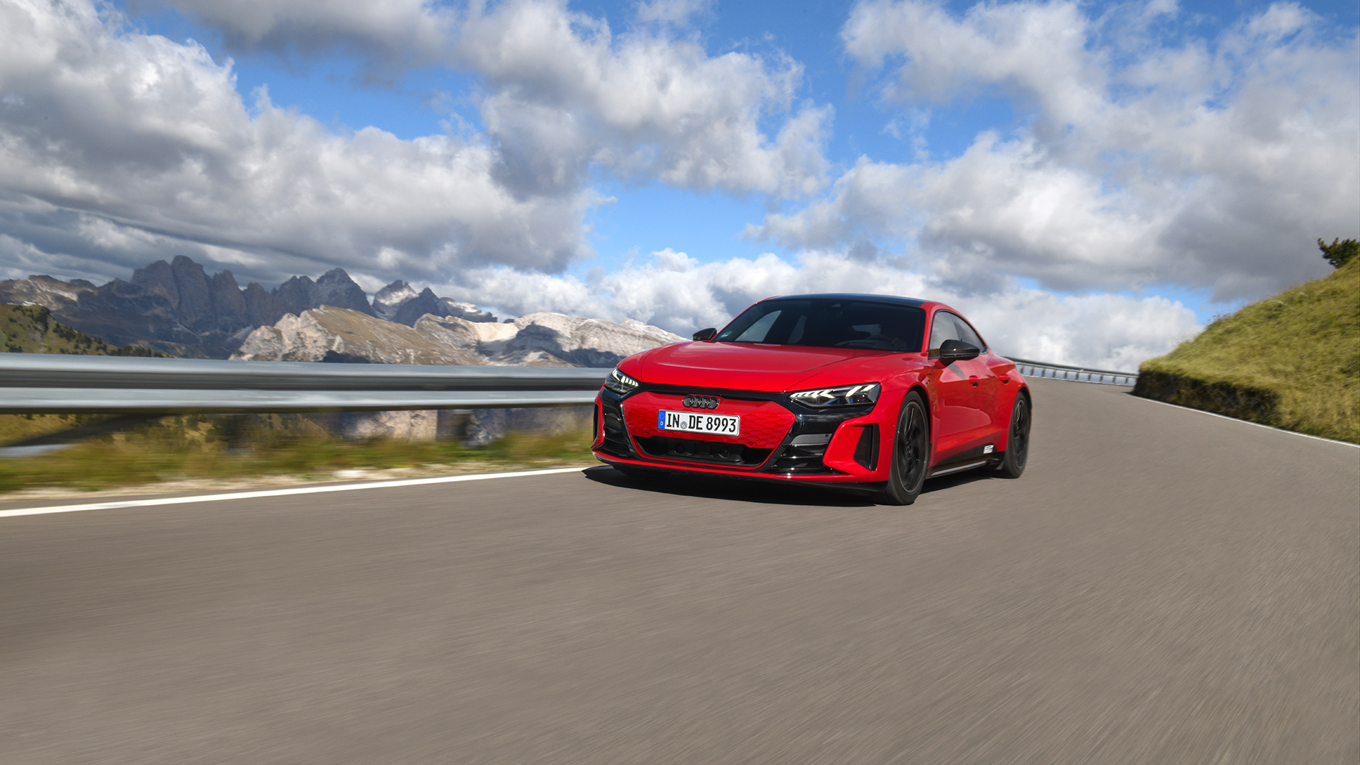 Red Audi R8 Spyder V10 performance quattro  (rear view) driving throug the mountains in great weather